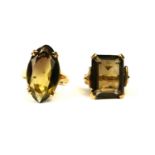 TWO 9CT GOLD AND SMOKY QUARTZ RINGS. (baguette cut ring size UK I½., navette cut ring size O. 10.8g)