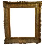 A LARGE LATE 18TH/EARLY 19TH CENTURY ENGLISH GILTWOOD AND GESSO FRAME Decorated with scrolling