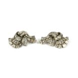 A PAIR OF ART DECO WHITE METAL AND DIAMOND CLUSTER BROOCHES. (tested for 18ct)