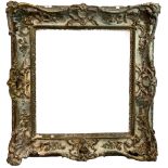 AN EARLY 19TH CENTURY PARCEL GILT AND PAINTED WOOD AND GESSO SWEPT FRAME Decorated with shells,