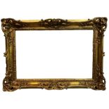 A 19TH CENTURY GILT AND GESSO SWEPT FRAME Decorated with shells, scrolling foliage and
