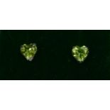 AN 18CT WHITE GOLD, HEART SHAPED PERIDOT STUDS. (Approx Peridot 1.30ct)