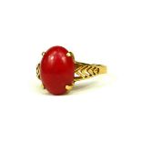 AN ORIENTAL 18CT GOLD AND RED JADE RING Having a stylised pierced shank, (UK size O, 3g)