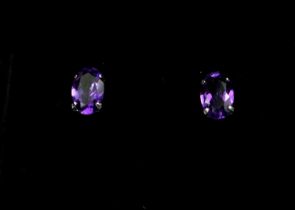 A PAIR 18CT WHITE GOLD AMETHYST STUDS. (Approx Amethyst 0.80ct)