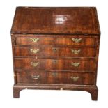 AN 18TH CENTURY WALNUT WRITING BUREAU/DESK The fall front opening to reveal a fitted interior
