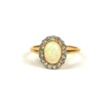 AN 18CT YELLOW GOLD, OPAL AND 17 DIAMOND CLUSTER RING Inside a Goldsmiths & Silversmiths, Regent