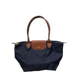 LONGCHAMP, A BLUE CANVAS BAG WITH BROWN LEATHER STRAP. (49cm x 45cm)