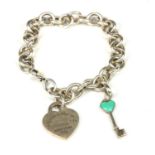 TIFFANY & CO., NEW YORK, A SILVER BELCHER LINK CHARM BRACELET Having heart form tag and key