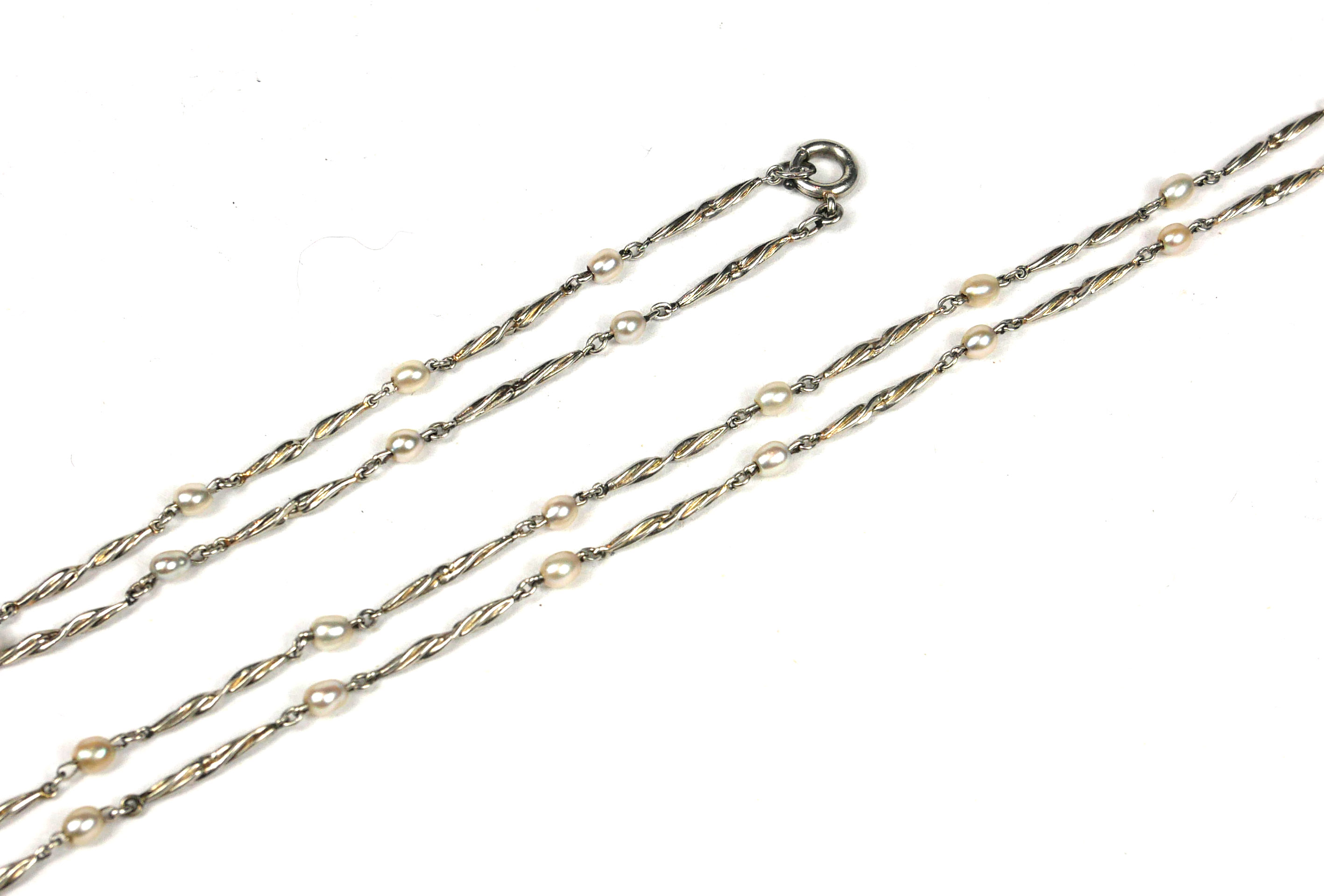 A WHITE METAL AND SEED PEARL NECKLACE AND MATCHING BRACELET, WHITE METAL TESTED AS PLATINUM. (length