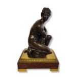 VENUS BATHING, A 19TH CENTURY BRONZE STATUE On gilded bronze and rouge marble stand. (36cm, 46cm