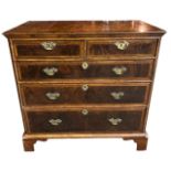 AN 18TH CENTURY WALNUT AND HERRINGBONE INLAID CHEST OF DRAWERS With quarter veneer top above two