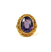 A LARGE 19TH CENTURY/20TH CENTURY HIGH CARAT YELLOW METAL AND ALEXANDRITE RING Having a chased