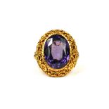 A LARGE 19TH CENTURY/20TH CENTURY HIGH CARAT YELLOW METAL AND ALEXANDRITE RING Having a chased