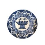 A CHINESE BLUE AND WHITE PLATE Decorated with a central flower basket surrounded by geometric floral