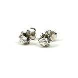 A PAIR OF WHITE METAL AND DIAMOND SOLITAIRE EARRINGS Screw back posts. (tested for 14ct, diamond