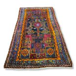 A 20TH CENTURY TURKISH WOOLLEN RUG Having a geometric design to central field, orange, red and