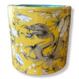 A LARGE CHINESE BRUSH POT Decorated with dragon amongst foliage on a yellow ground, bearing a four