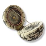 A CARVED BONE GLOBE POCKET COMPASS Having black decoration to outer surface and glazed compass to