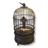 A PIERCED BRASS BIRDCAGE MANTEL CLOCK Dome form with revolving central column and moving bird. (
