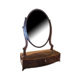 A GEORGIAN MAHOGANY DRESSING TABLE MIRROR Having an oval swing mirror,and three drawers to base. (