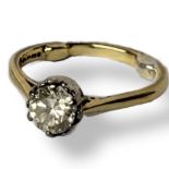 AN 18CT GOLD SOLITAIRE DIAMOND RING The single round cut diamond of plain design. (approx diamond