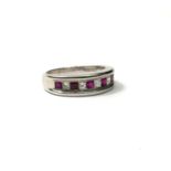 AN 18CT WHITE GOLD, RUBY AND DIAMOND RING Having an alternating central square cut diamond and