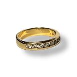 AN 18CT GOLD AND DIAMOND ETERNITY RING The single row of round cut diamonds in a channel setting. (