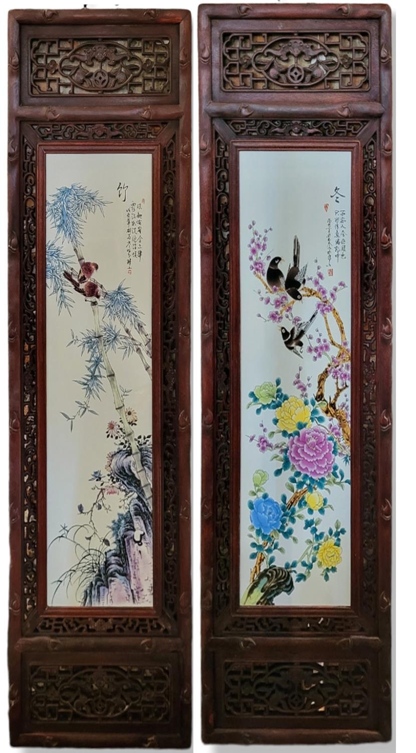 A PAIR OF 20TH CENTURY CHINESE HARDWOOD MOUNTED PORCELAIN PLAQUES Depicting a group of Oriental