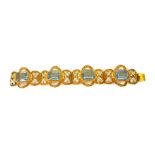 A VINTAGE CONTINENTAL SILVER GILT FILIGREE AND PASTE BRACELET Having four baguette cut pale blue