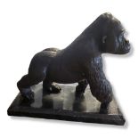 A BRONZE AND MARBLE STANDING GORILLA STATUE With textured decoration, on a stepped marble base. (