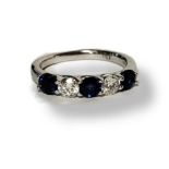 A WHITE METAL, DIAMOND AND SAPPHIRE FIVE STONE RING Three round cut sapphires interspersed with