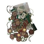 ROLEX, A COLLECTION OF VINTAGE RED AND GREEN HANG TAG SEALS Red circular tags with hologram and