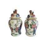 A PAIR OF CHINESE VASES VASES AND COVERS With kylin finials and enamelled decoration in the form