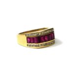 A LARGE 14CT GOLD, RUBY AND DIAMOND RING Having eleven baguette cut rubies flanked by two rows of