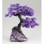 A LARGE AMETHYST GEMSTONE TREE ON AMETHYST GEODE (h 41cm x w 40cm x d 32cm)