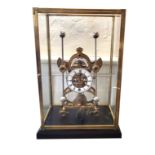 A LARGE BRASS SKELETON MANTEL CLOCK Having four glazed panels, a white circular dial and two