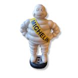 A CAST IRON MICHELIN MAN ADVERTISING FIGURE Standing form with yellow sash and tyre to feet. (approx