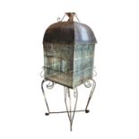 A LARGE 19TH CENTURY PAINTED IRON AND ZINC DOMED TOPPED BIRDCAGE ON WROUGHT IRON SCROLL WORK