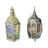 TWO VERDIGRIS METAL STORM LANTERNS With pierced domed tops above glazed panels. Condition: good