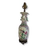 A CHINESE PINK GROUND FAMILLE ROSE PORCELAIN LAMP Having applied green glaze dogs of fo and