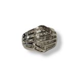 A 9CT WHITE GOLD AND DIAMOND CLUSTER RING Five rows of round cut diamonds edged with baguette cut