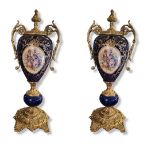 A PAIR OF 20TH CENTURY DECORATIVE SÃˆVRES STYLE GILT METAL MOUNTED PORCELAIN URNS AND COVERS Both