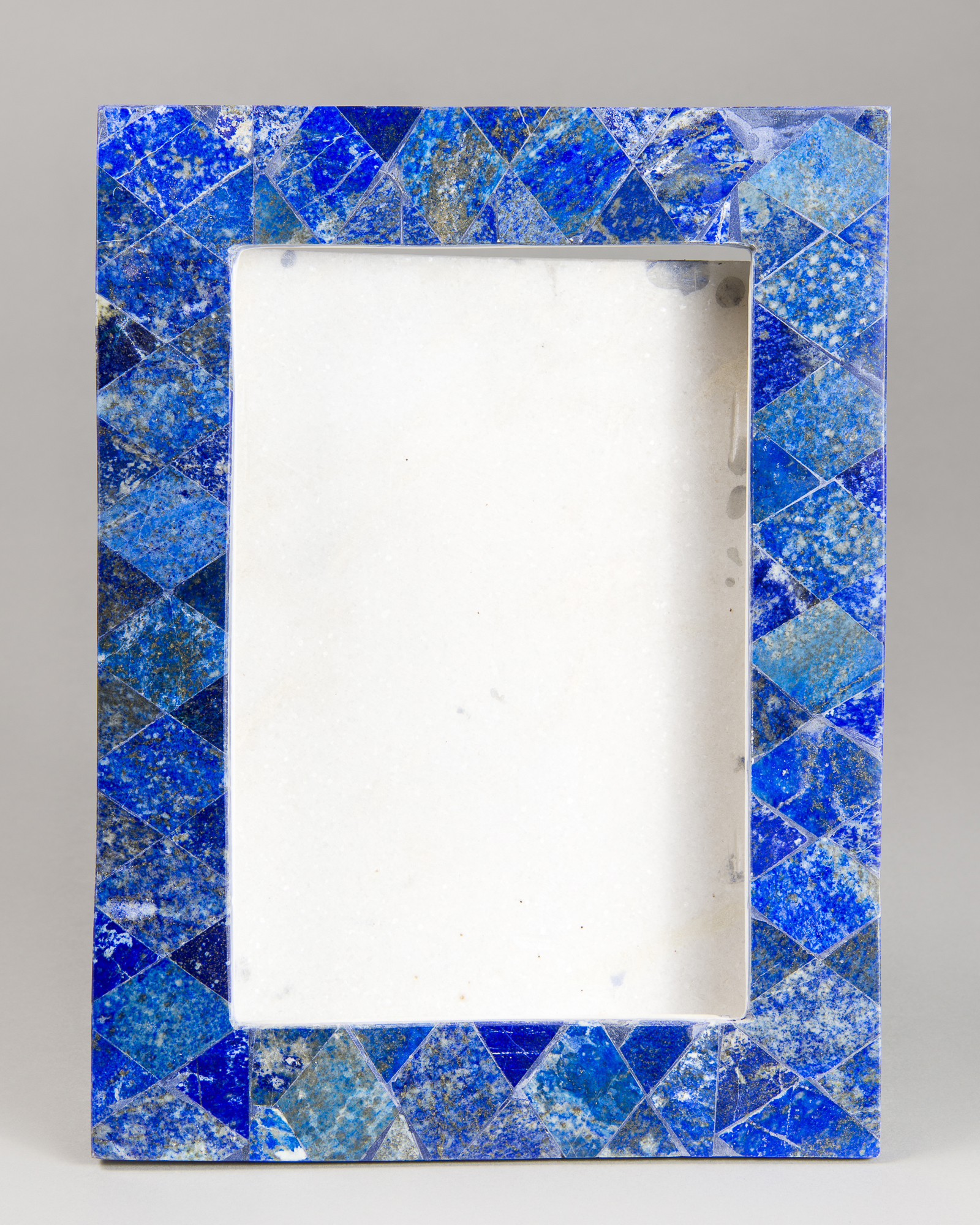 A LAPIS LAZULI PICTURE FRAME ON WHITE MARBLE (h 31cm x w 33cm x d 8cm)