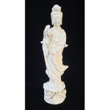 AN EARLY 20TH CENTURY CHINESE DEHUA BLANC DE CHINE FIGURE OF GUANYIN In long flowing lace robes,