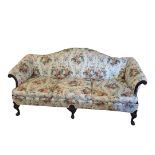 AN EARLY 20TH CENTURY REGENCY STYLE MAHOGANY CAMEL BACK SETTEE With carved show wood frame