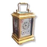 A GILT BRASS AND BEVELED GLASS CARRIAGE CLOCK With porcelain multi dial face and three hand
