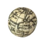 A BONE COMPASS FORMED AS A WORLD GLOBE. (h 4.4cm x diameter 4.1cm)