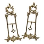 A PAIR OF BRASS TABLE EASELS Decorated with scrolling foliage. (h 52cm x w 25cm)