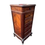 A 19TH CENTURY FRENCH WALNUT AND ROSEWOOD BEDSIDE CHEST The rouge marble top above drawers and a pot