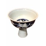 A CHINESE BLUE AND WHITE STEM CUP Decorated with two dragons amongst clouds. (h 8.9cm x diameter 9.